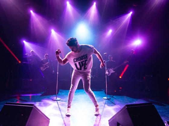 On stage wearing a white outfit