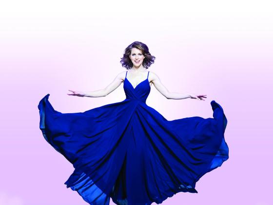 Woman suspended in air with flowy blue dress