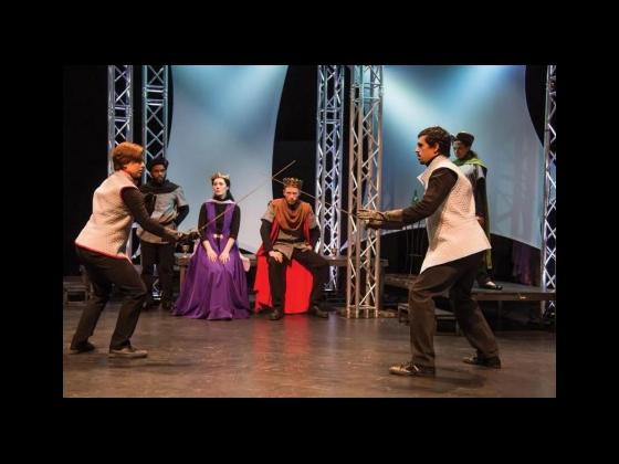Two men sword fighting on stage