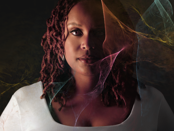 Woman with half her face in shadow and colorful smoke-like texture