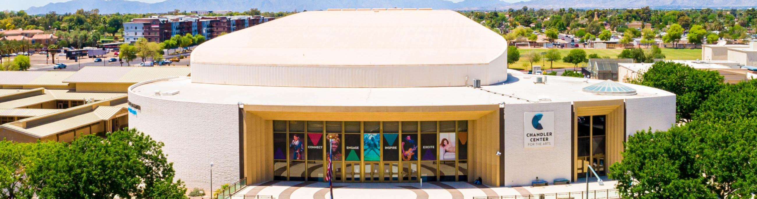 Aerial view of the front of a performing arts center with a blue sky in the background