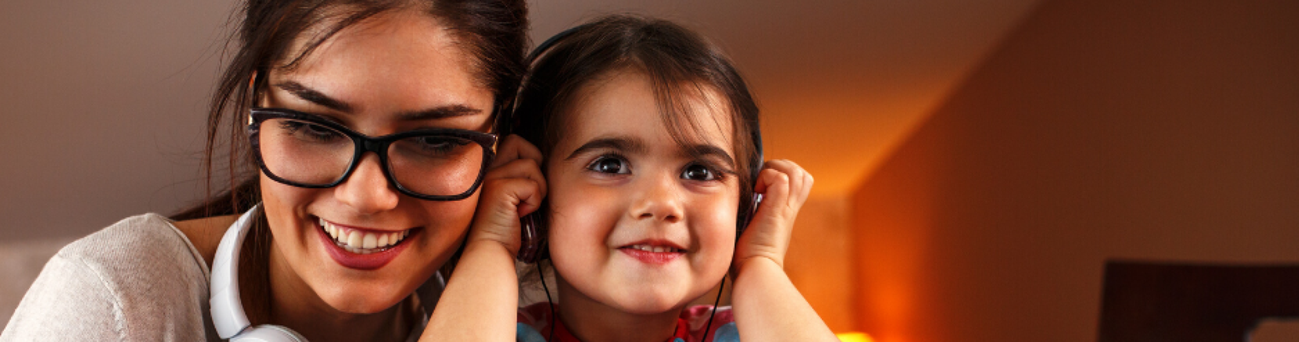 A mother and daughter engaging in an onscreen activity