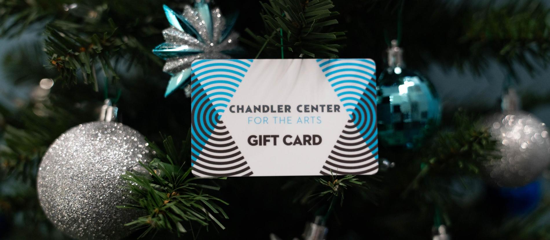 CCA gift card in tree with blue and silver ornaments
