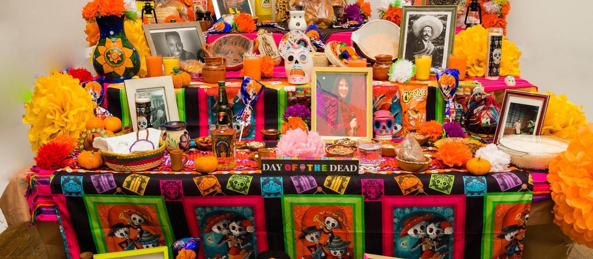 Community altar laden with photos and treats.