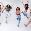 Five women pose in different dance moves from jumping to kicking