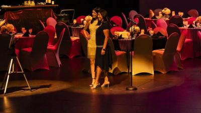 Round tables on top of the mainstage, decorated for a fundraising event