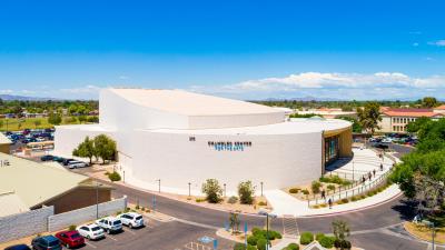 An aerial view of the performing arts center from the south with blue skies in the background
