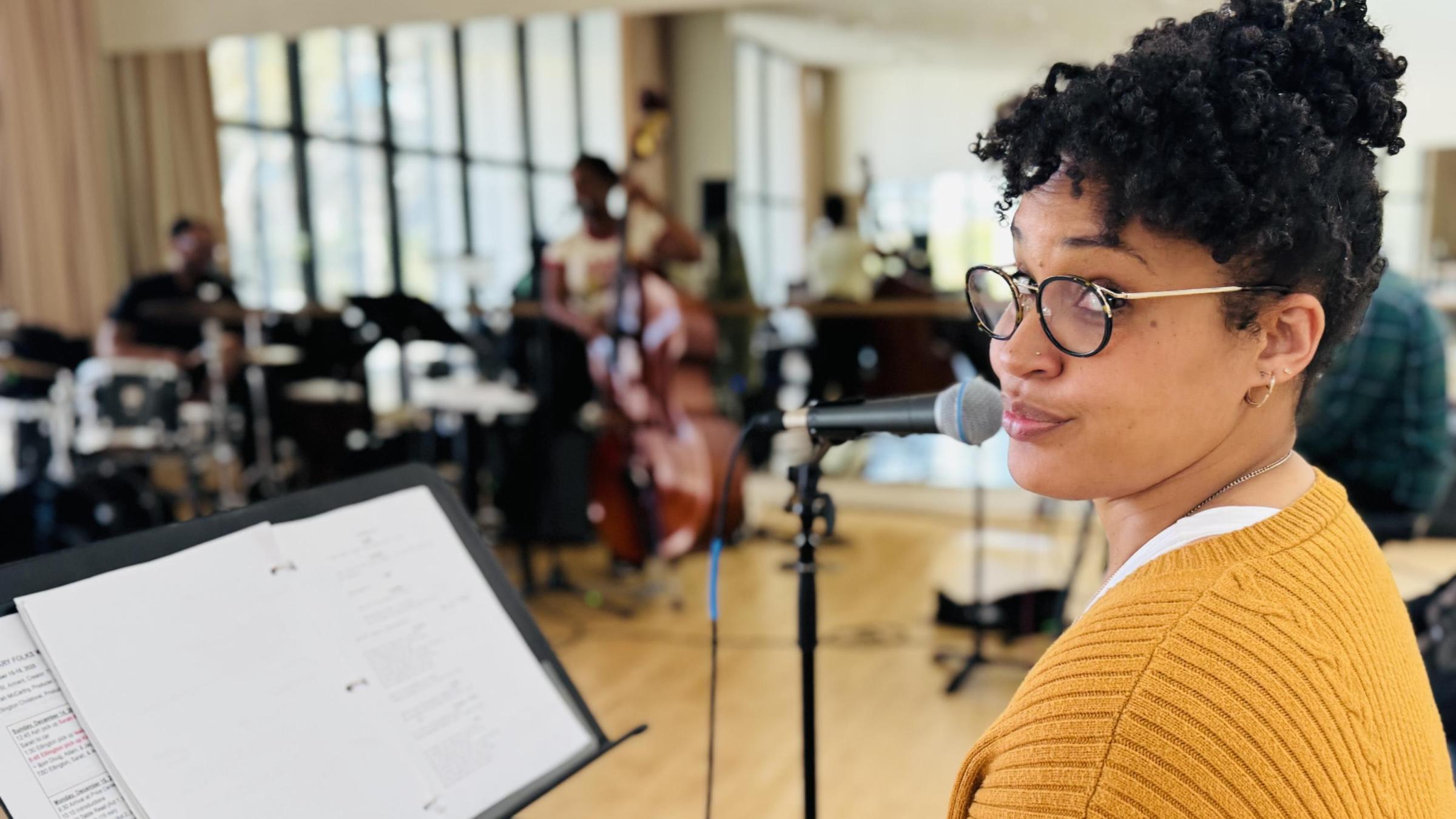 Ashli in a room of musicians