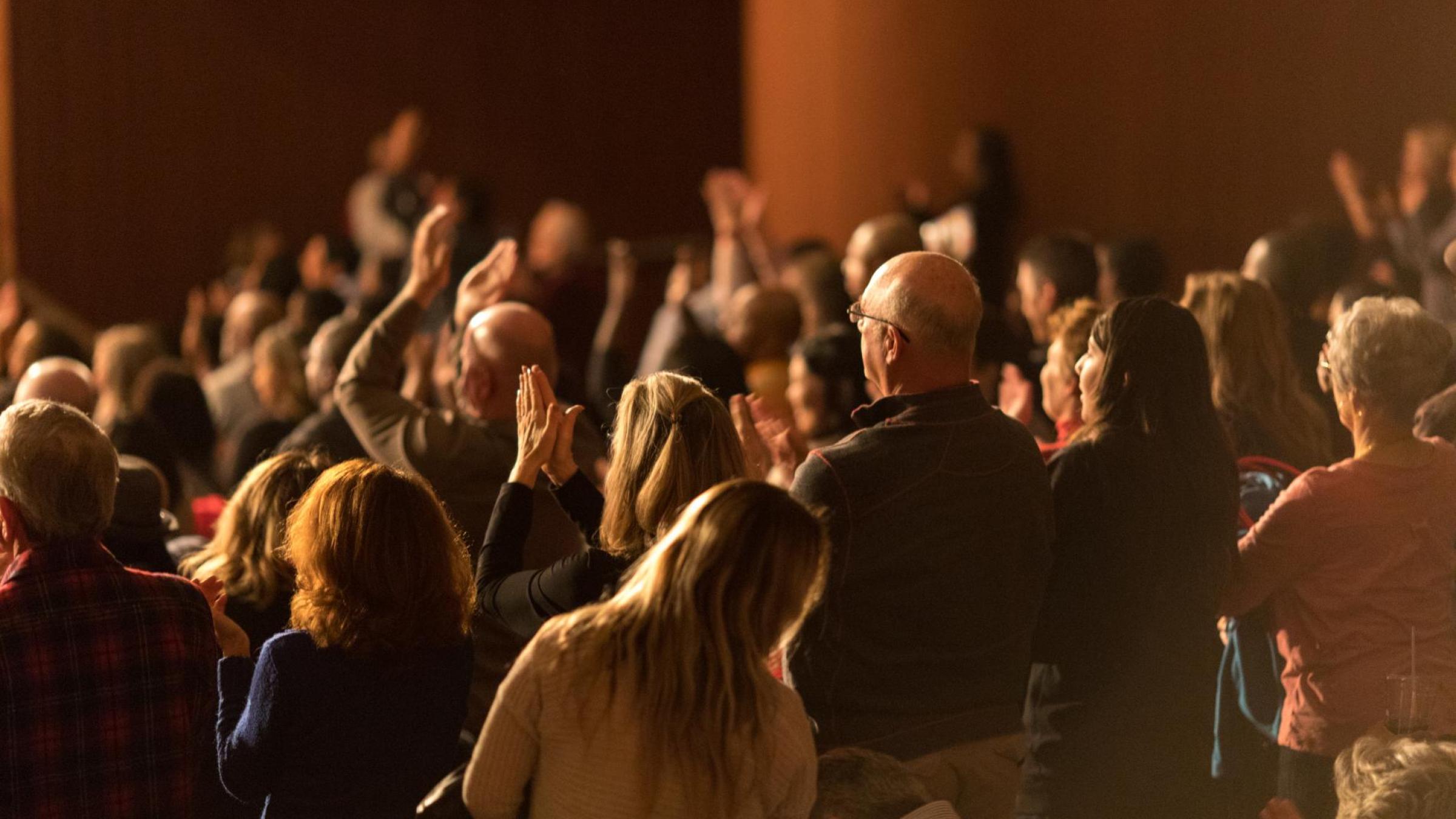 Fans clapping in audience