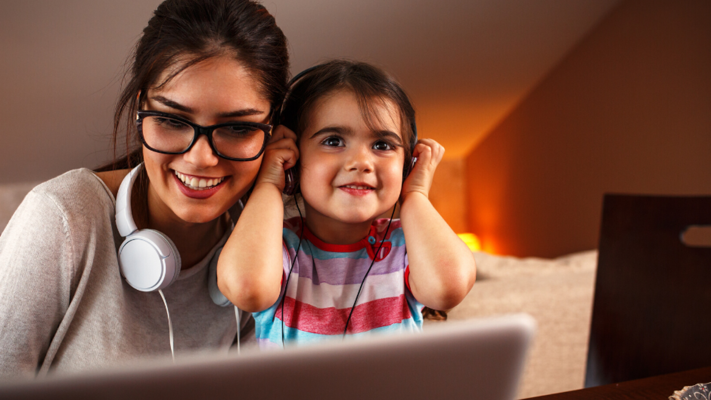 A mother and daughter engaging in an onscreen activity